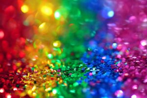 Colorful bokeh effect with vibrant rainbow glitter, perfect for festive backgrounds.